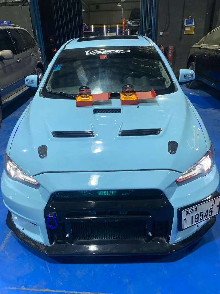 Light blue Mitsubishi Lancer Evolution race build in the garage