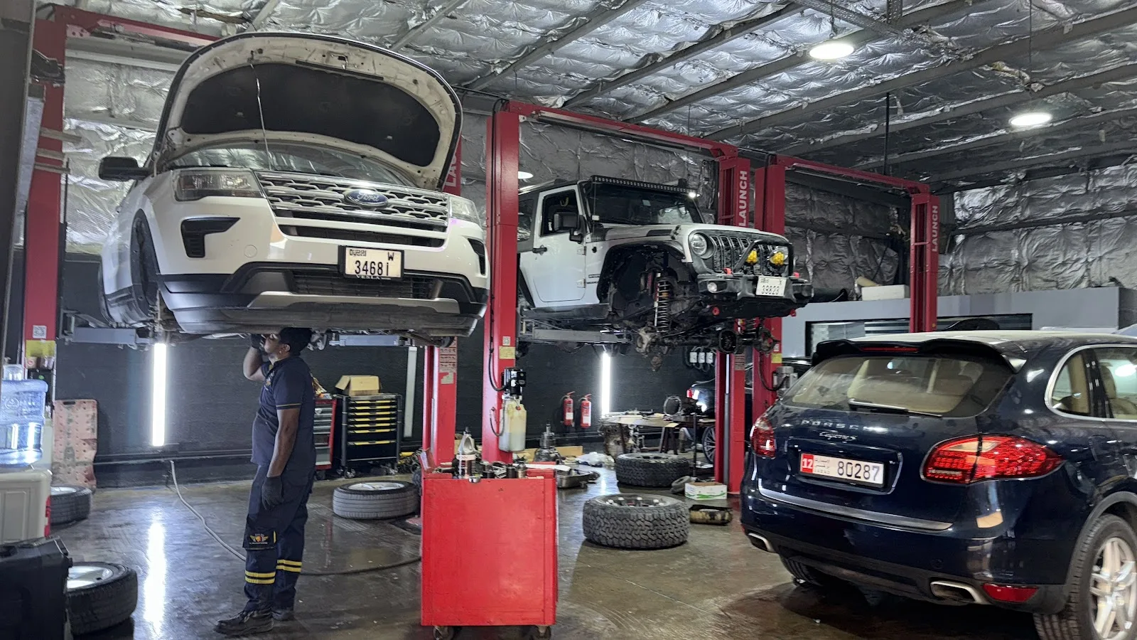 Vehicles raised on lifts inside Al Bedayer Garage workshop in Al Quoz, Dubai