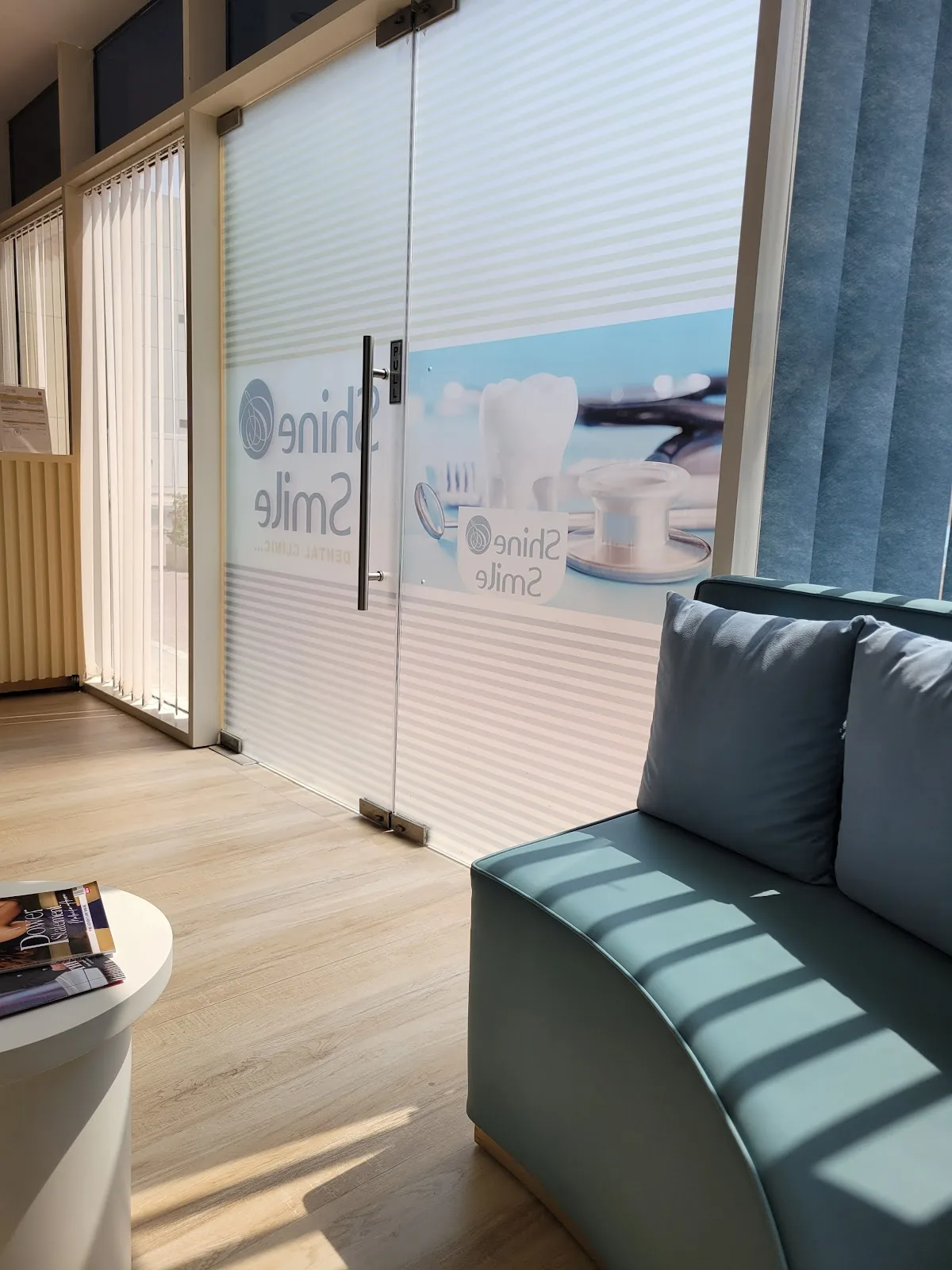 Waiting area with branded glass door and soft seating