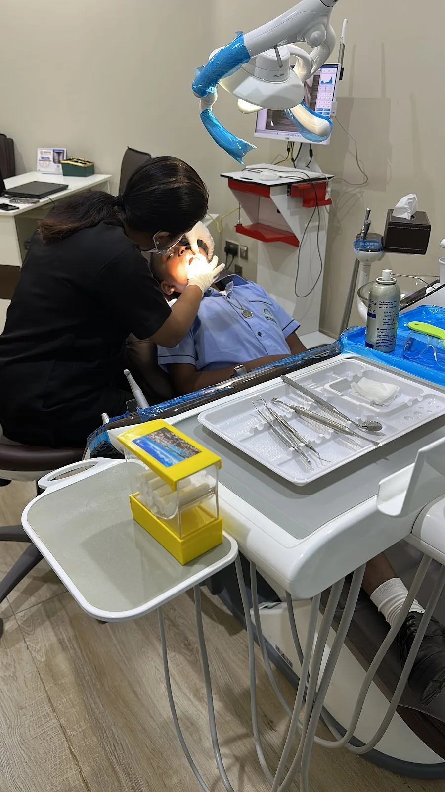 Dentist gently treating a young patient at the clinic