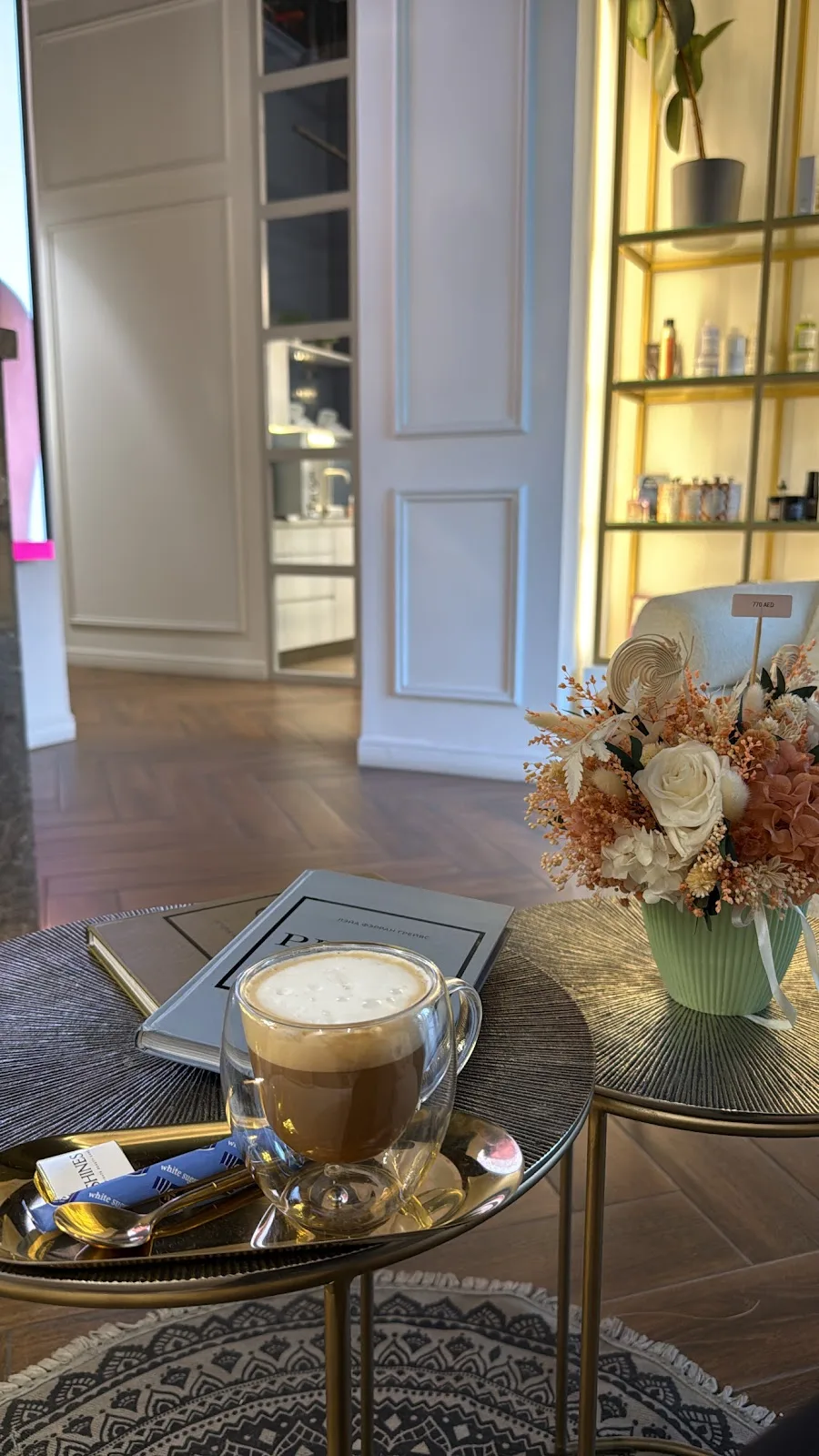 Coffee and flowers on a brass table