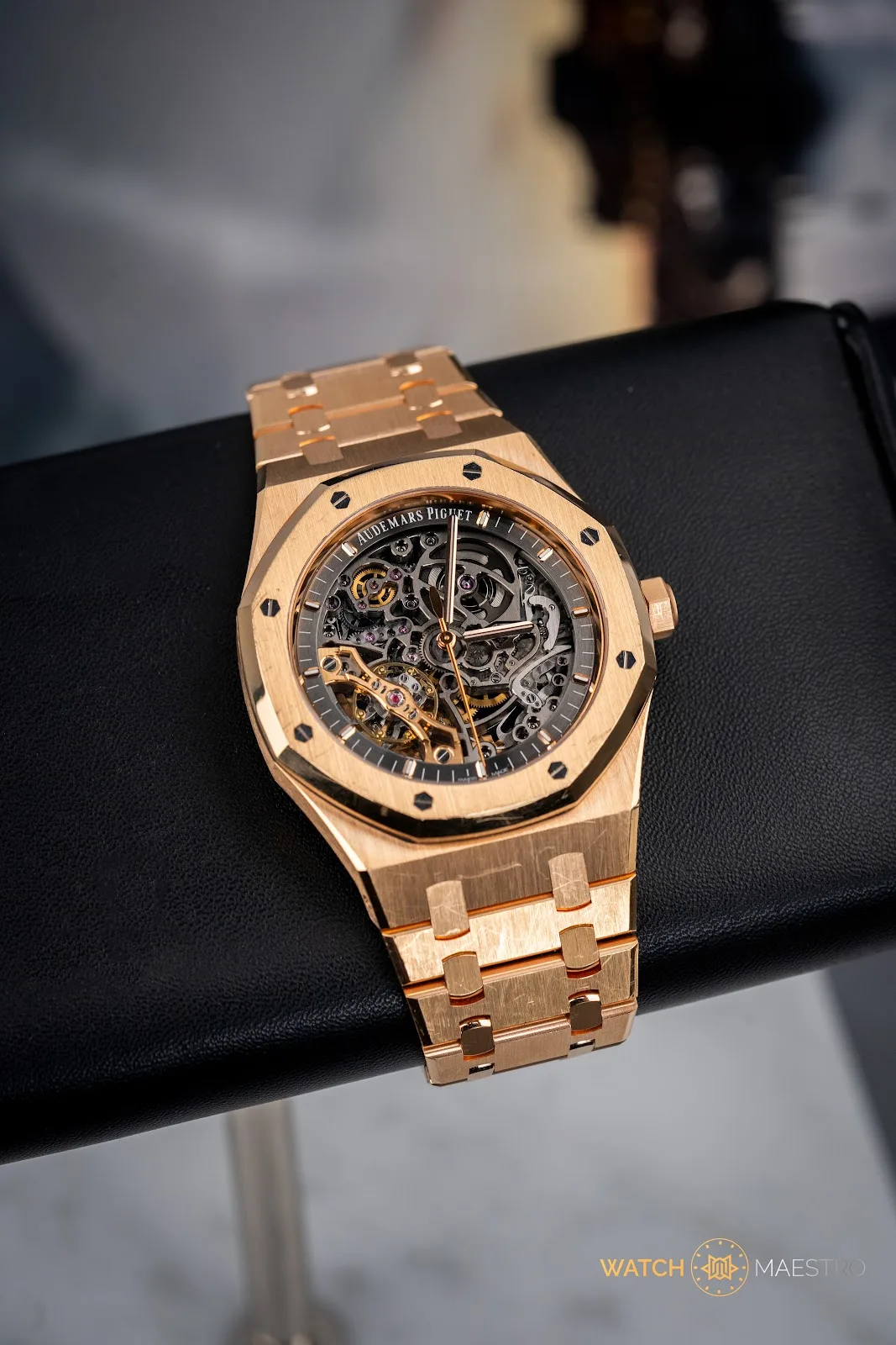 Rose-gold openworked Audemars Piguet Royal Oak skeleton resting on black leather