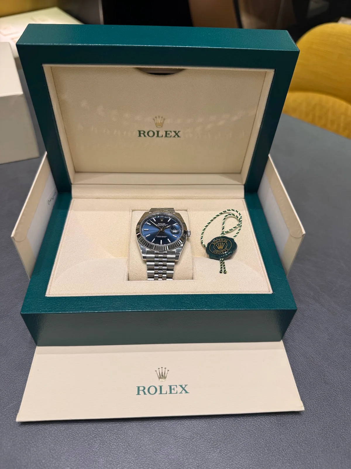 Rolex Datejust with blue dial presented in a green Rolex box
