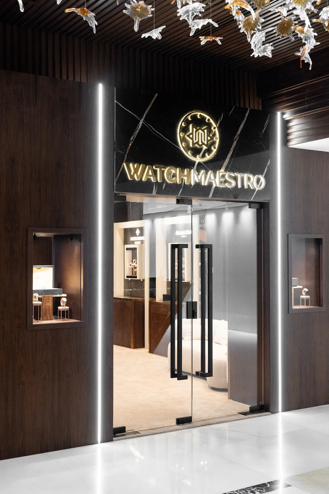 WatchMaestro boutique entrance with illuminated gold signage and display windows