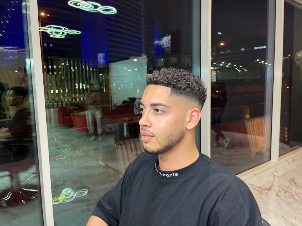Curly top with a low fade