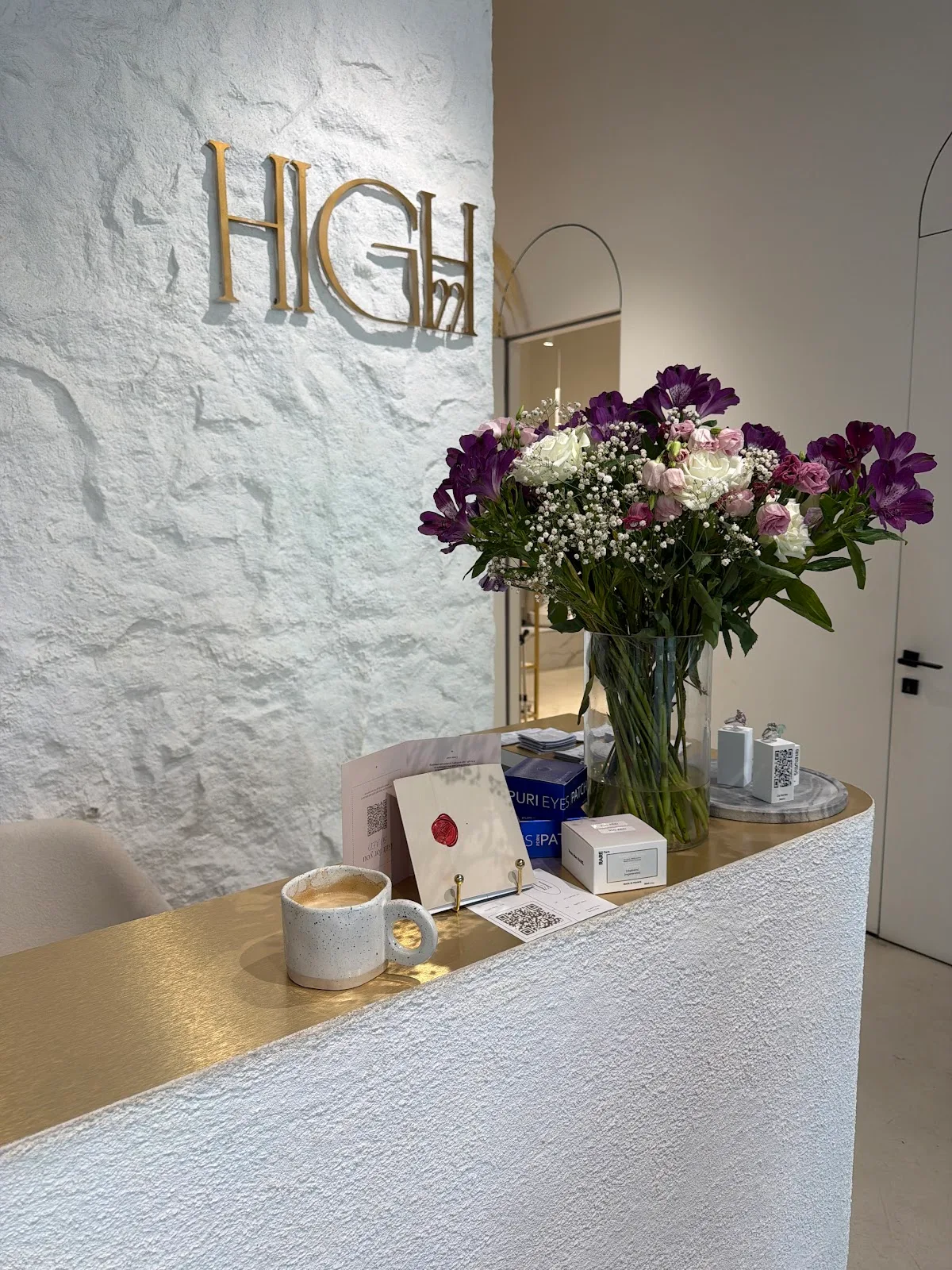 HIGH22 reception with the gold studio sign and fresh flowers