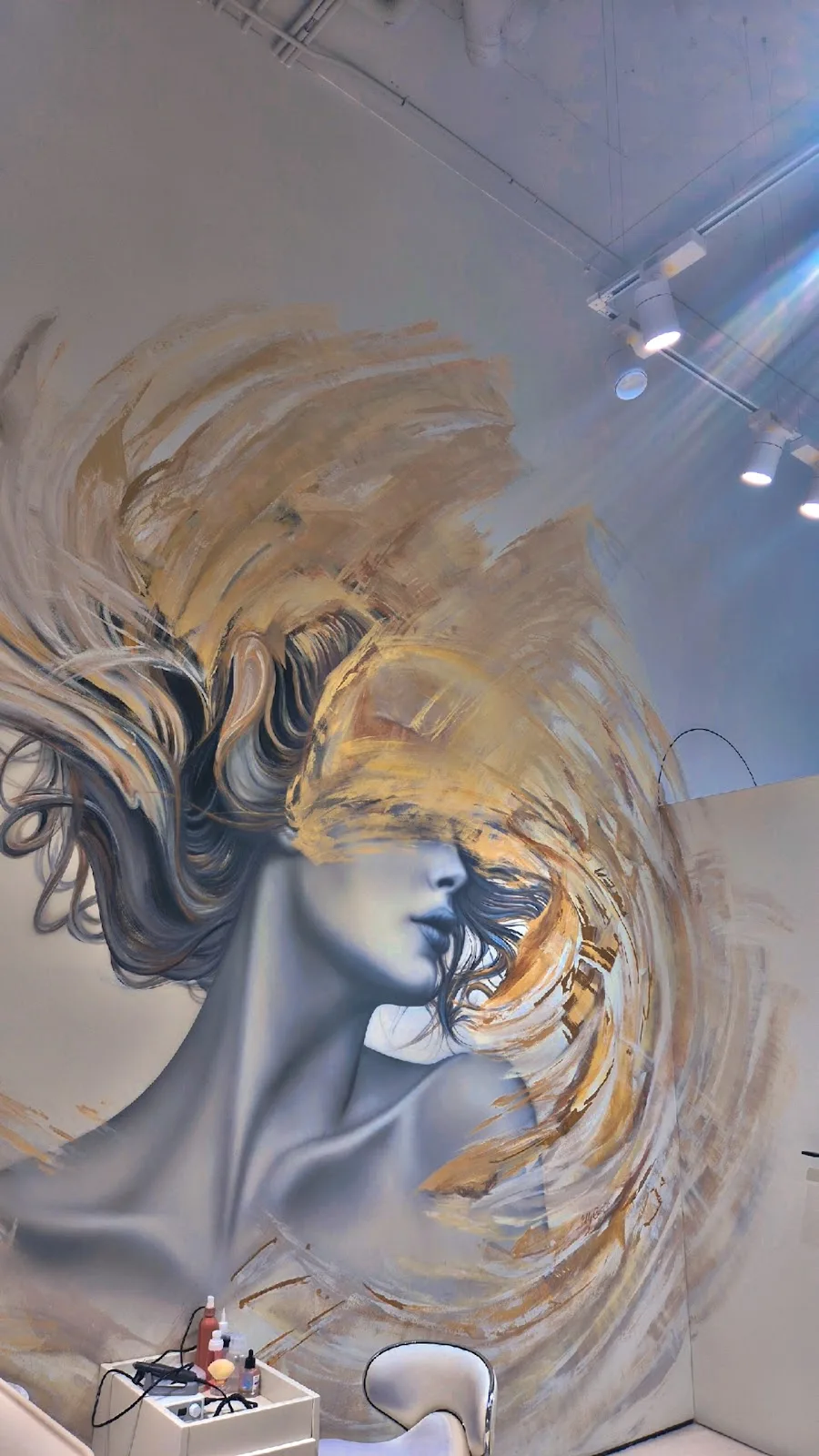 Hand-painted golden mural inside the HIGH22 studio