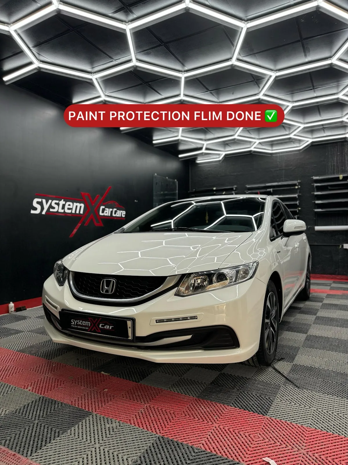 A white sedan after paint protection film at System X Car Care