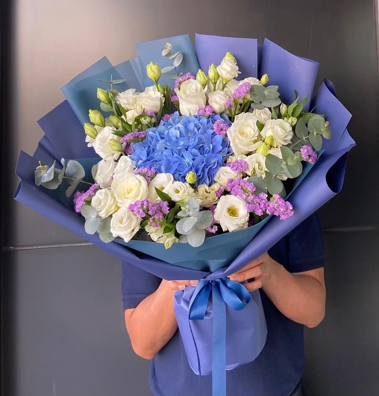 Blue hydrangea bouquet with white roses and statice