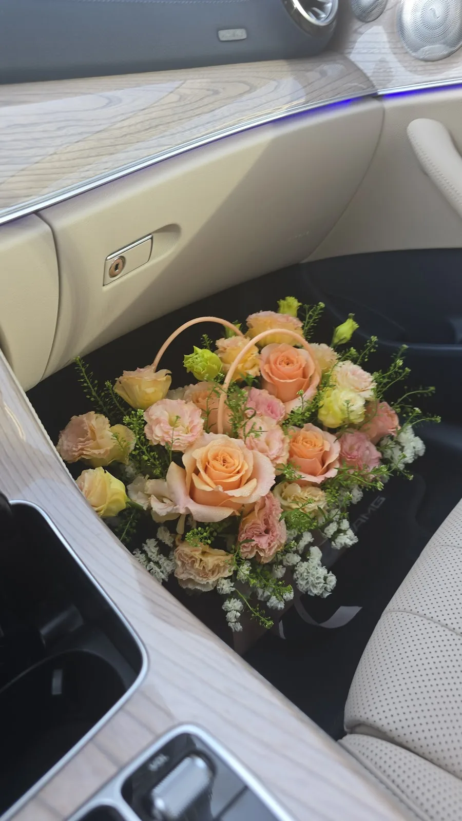 Peach and cream bouquet resting on a car seat