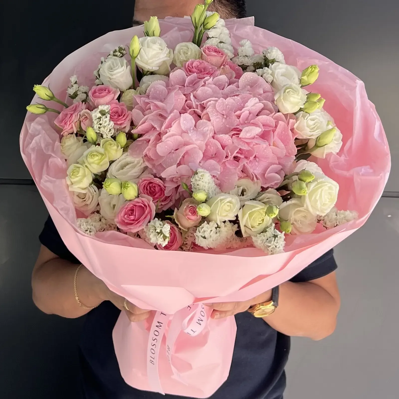 Round bouquet of pink and white roses and hydrangea