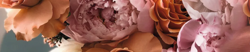 Close-up of blush and copper peonies and garden roses