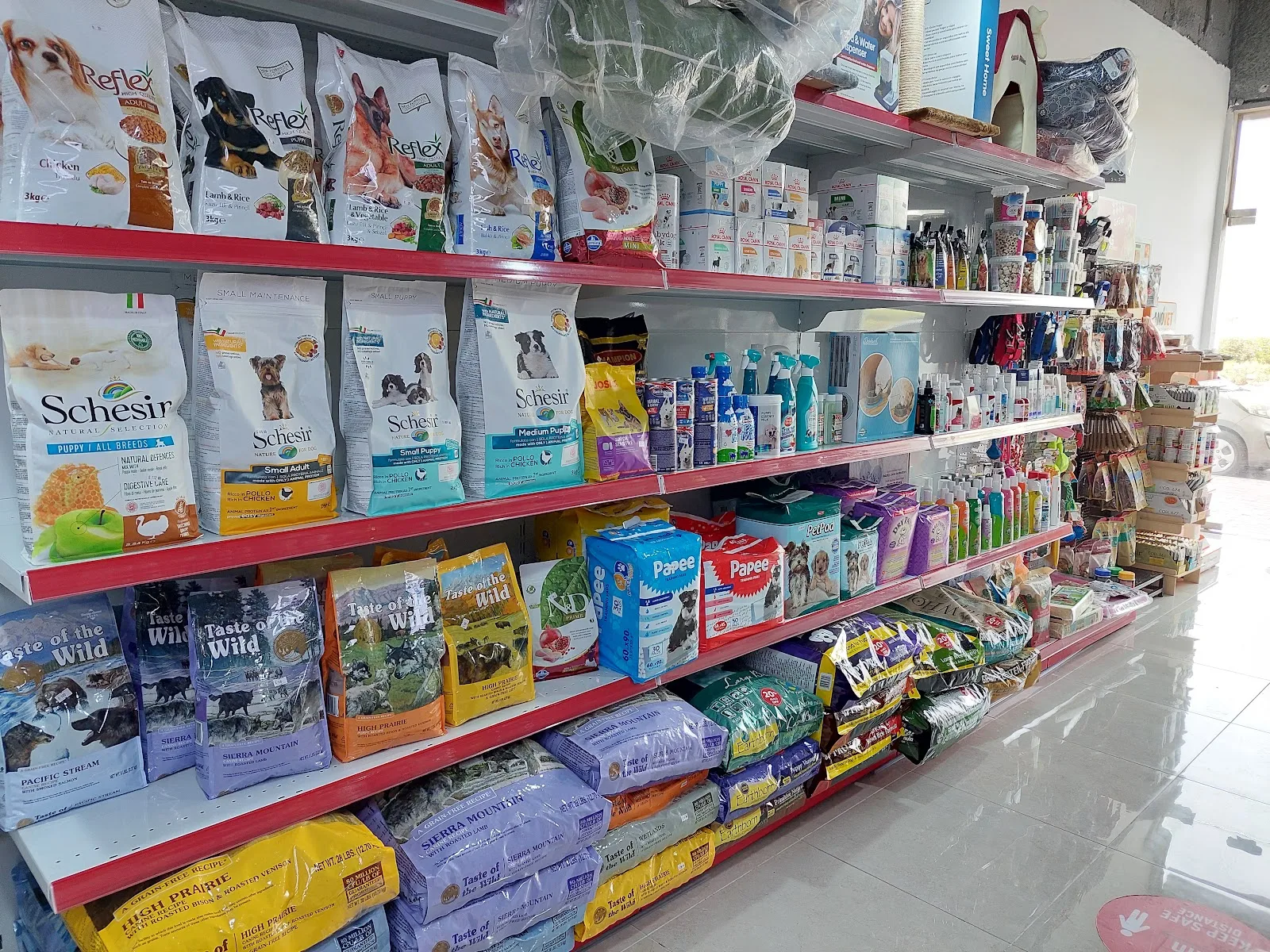 Shelves of pet food and care products inside the boutique
