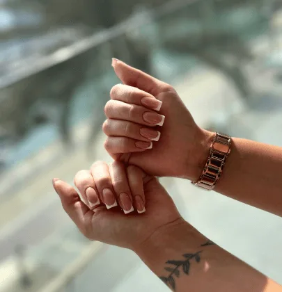 Neutral manicure with a rose-gold watch