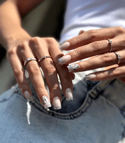Manicured nails with delicate French and crystal detailing