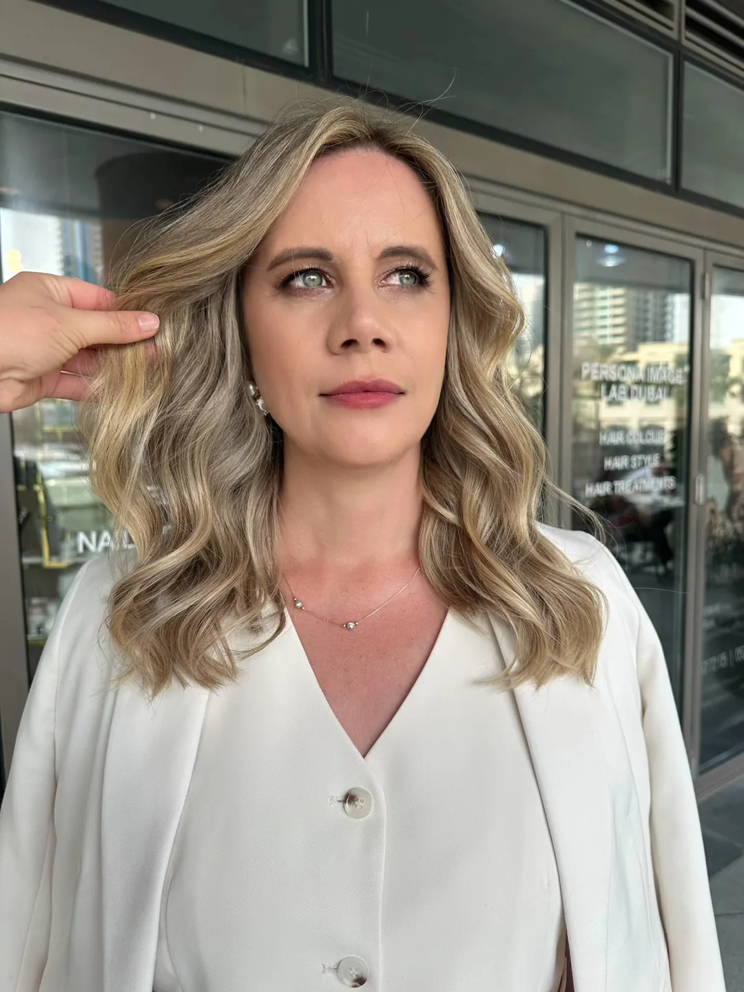 Soft blonde waves styled outside the Marina salon