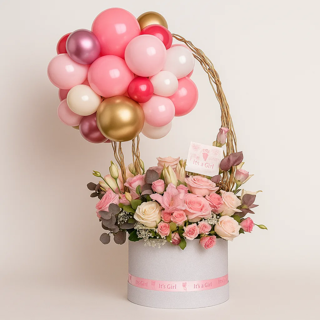 Pastel pink flower arrangement with a balloon topper for a new baby girl
