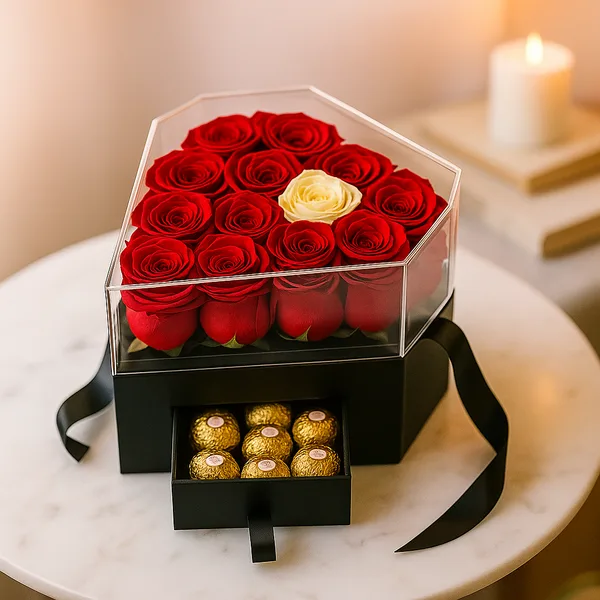 Heart-shaped clear box of red roses over a chocolate drawer