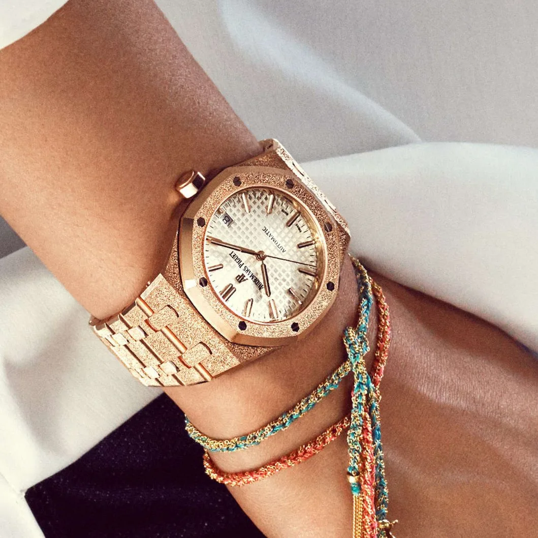 A rose-gold ladies' watch with a frosted finish worn on the wrist