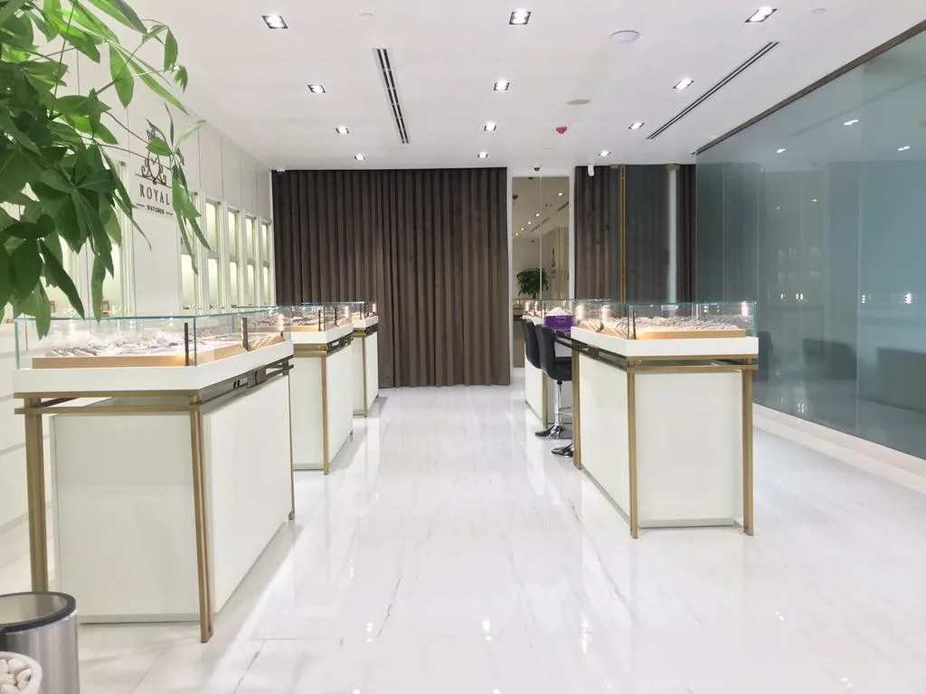 The Royal Watches showroom with rows of lit glass display cabinets