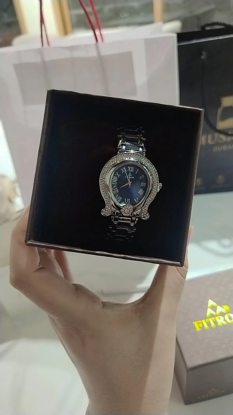 A diamond-set ladies' watch with a deep blue dial in its box