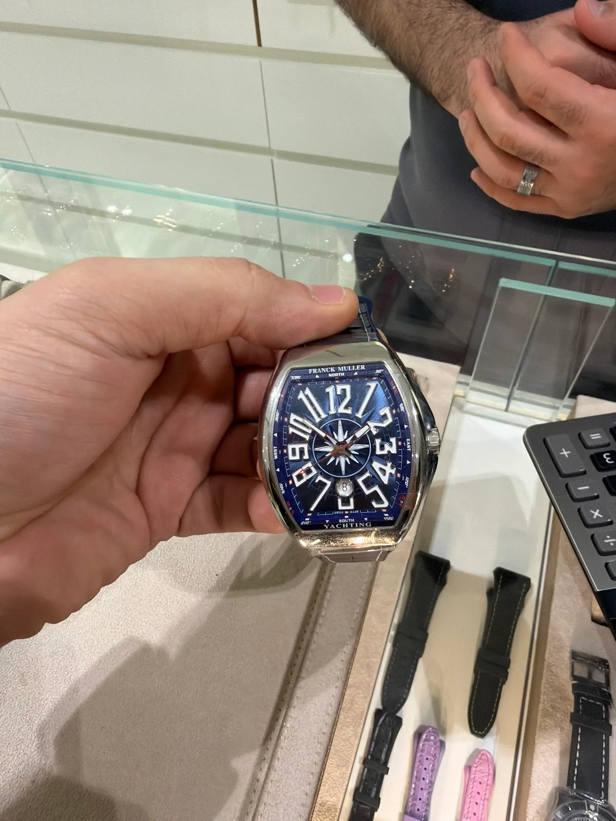 A watch being presented to a customer across the counter