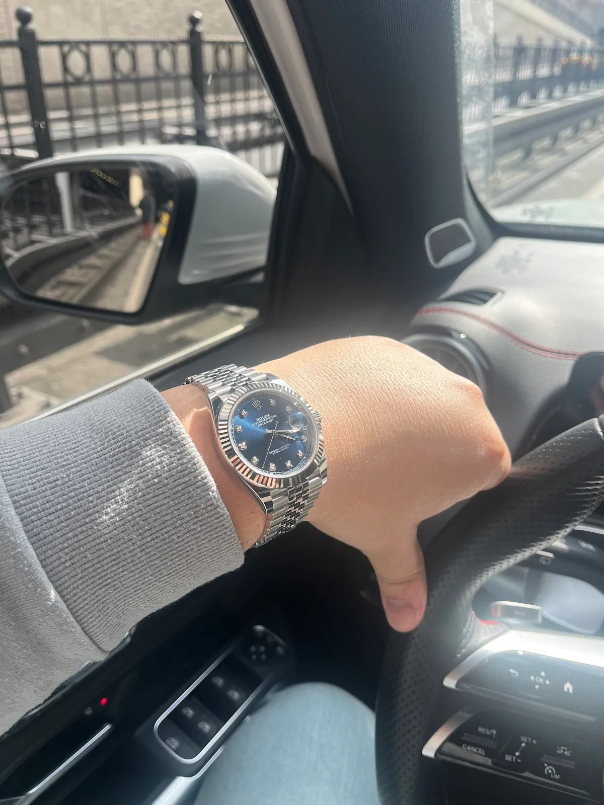 A Rolex Datejust with a blue dial and diamond markers worn on the wrist