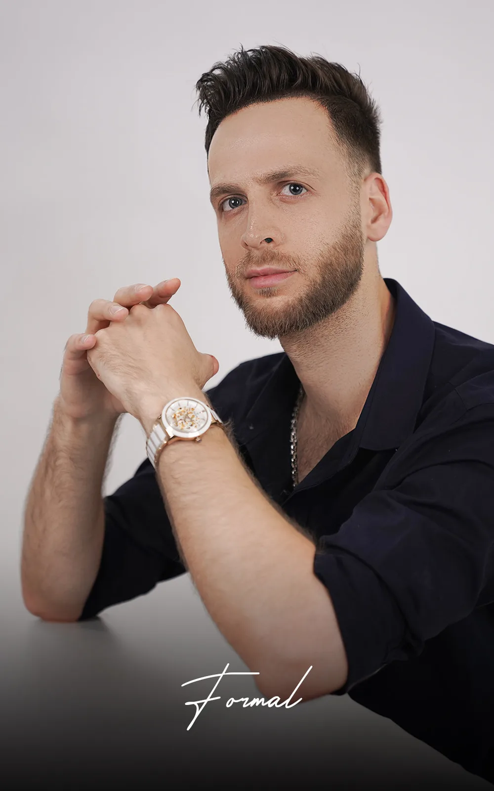 Man wearing a rose-gold and steel Sveston dress watch