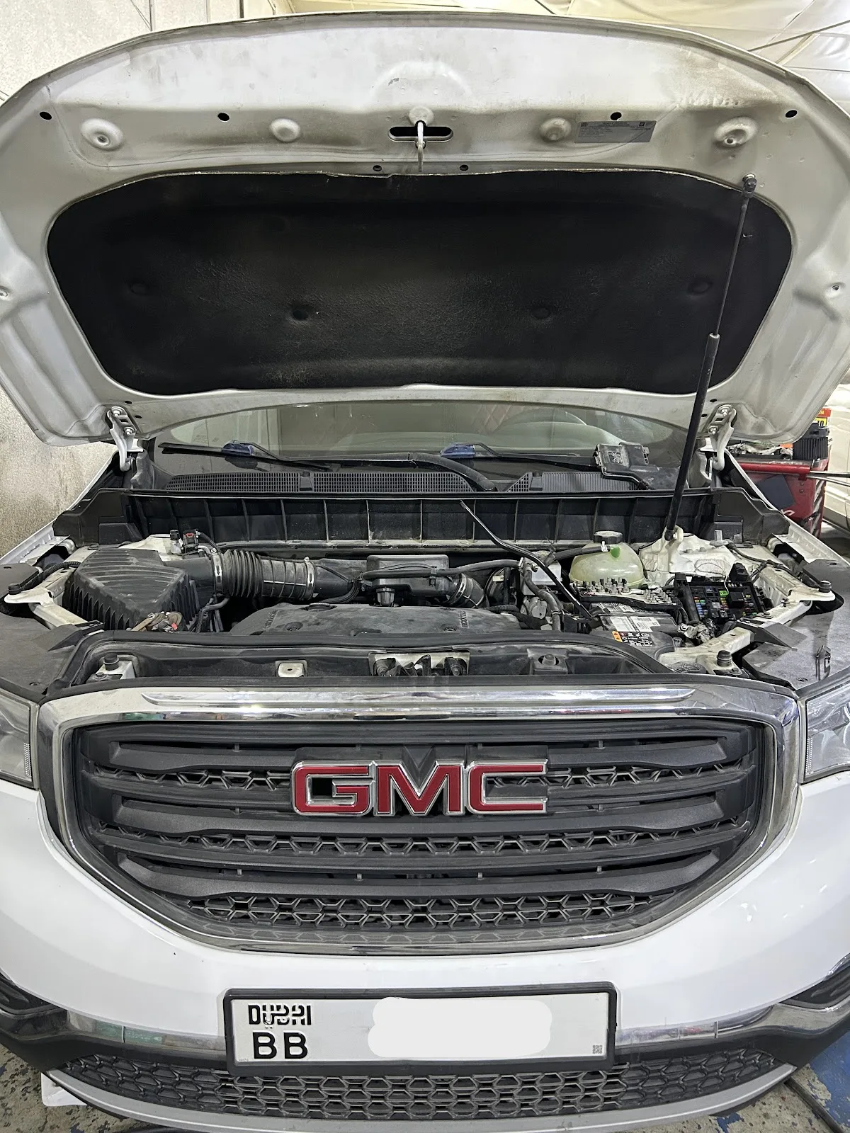 GMC engine bay open during a service