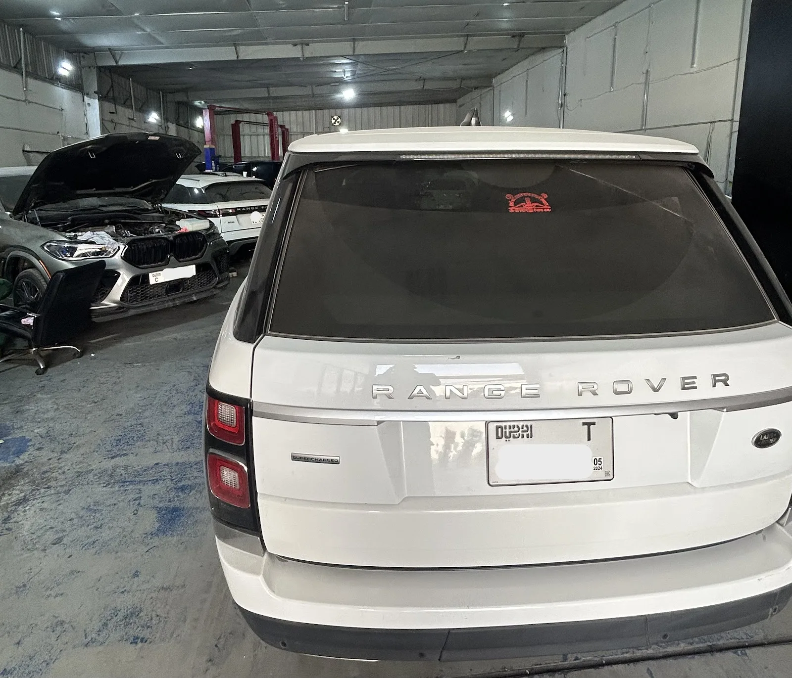 White Range Rover parked in the workshop