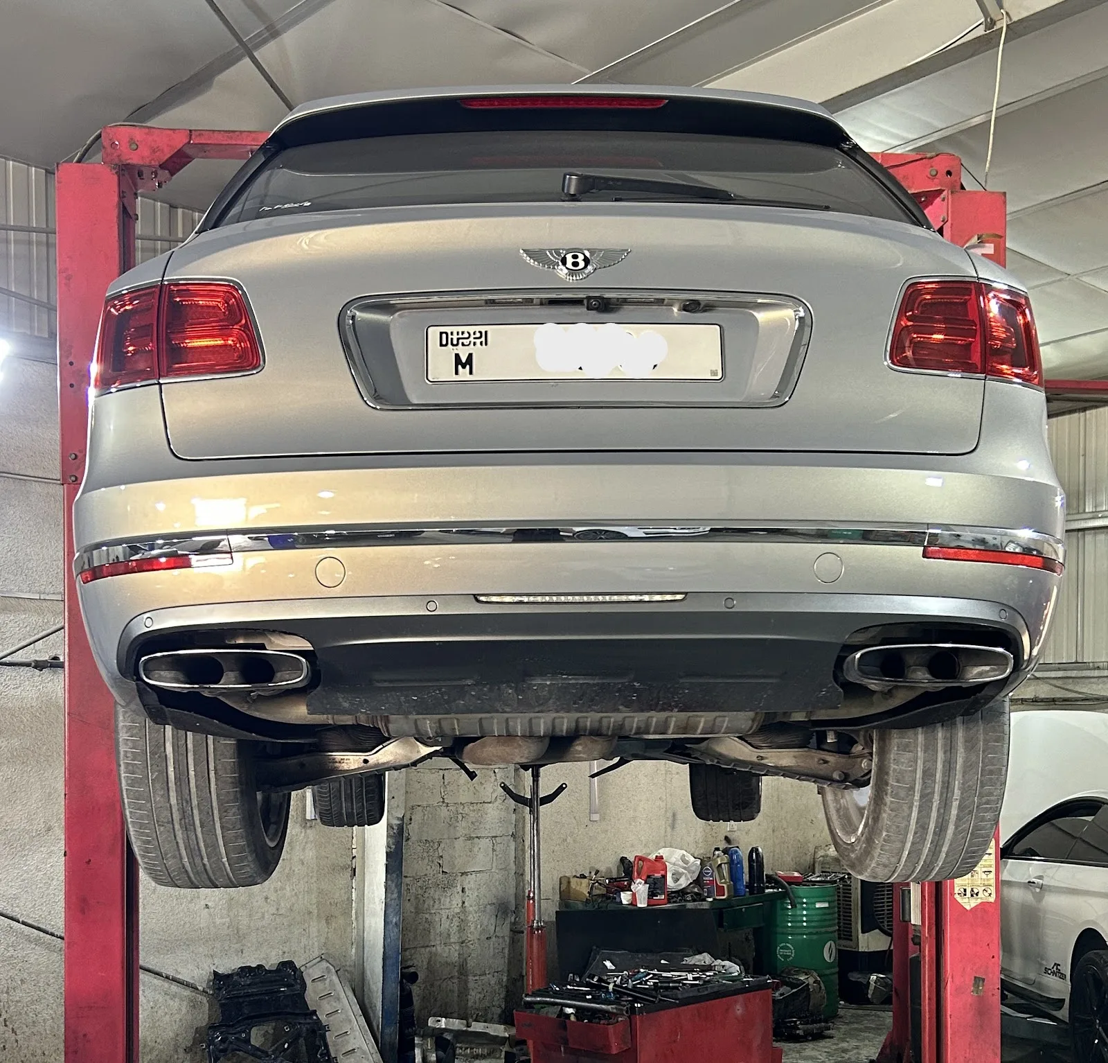 Bentley Bentayga raised on the lift for underside inspection