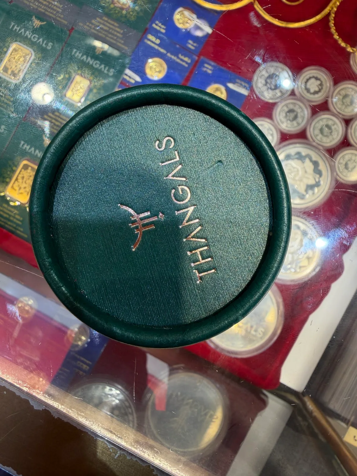 Top of a green Thangals ring box embossed with the logo in gold