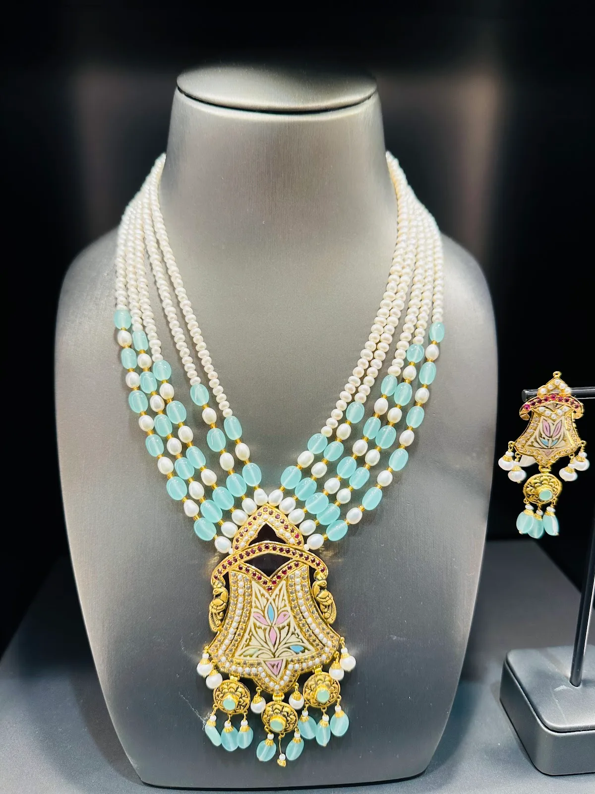 Gold necklace set with pearls and turquoise beads and a painted enamel pendant