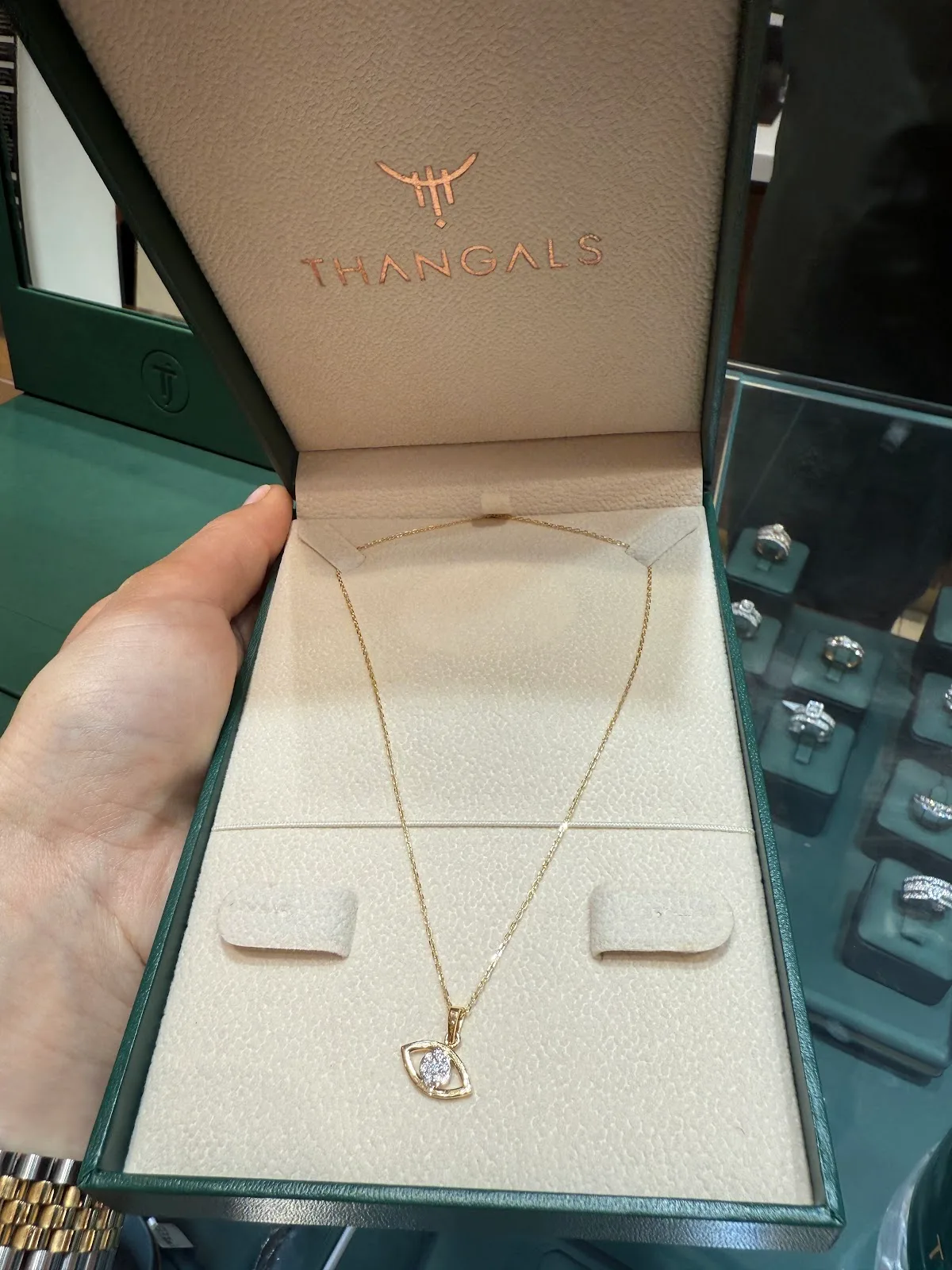 Evil-eye diamond pendant on a fine gold chain in a Thangals box