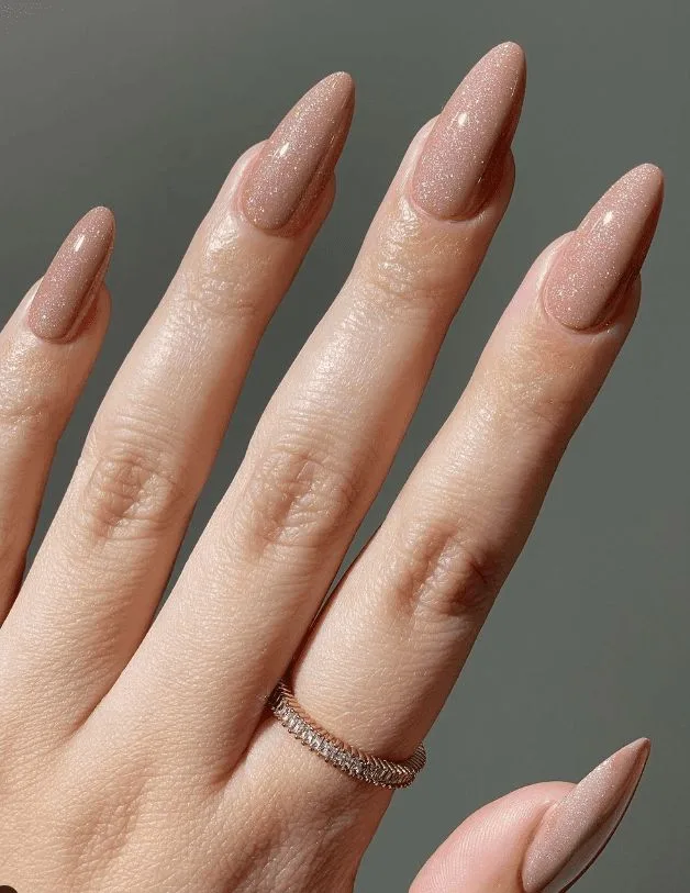 Glittery nude almond nails