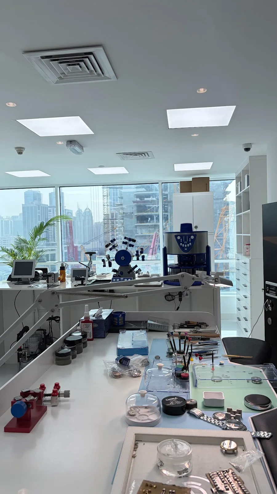 The ChronoStreet watch workshop with benches, microscopes and a view over Dubai