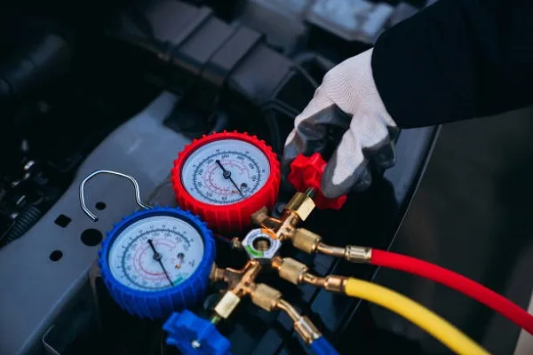 AC pressure gauges connected to a car air-conditioning system