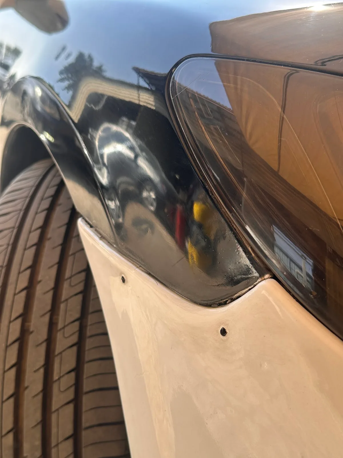 Close-up of a car body panel being assessed for dent repair