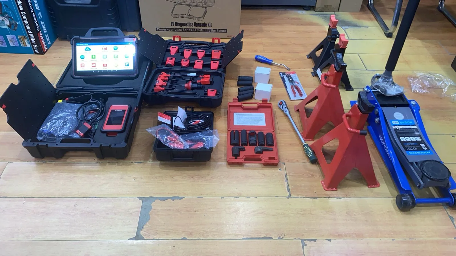 Diagnostic tablet, sockets, jack and axle stands laid out in the workshop