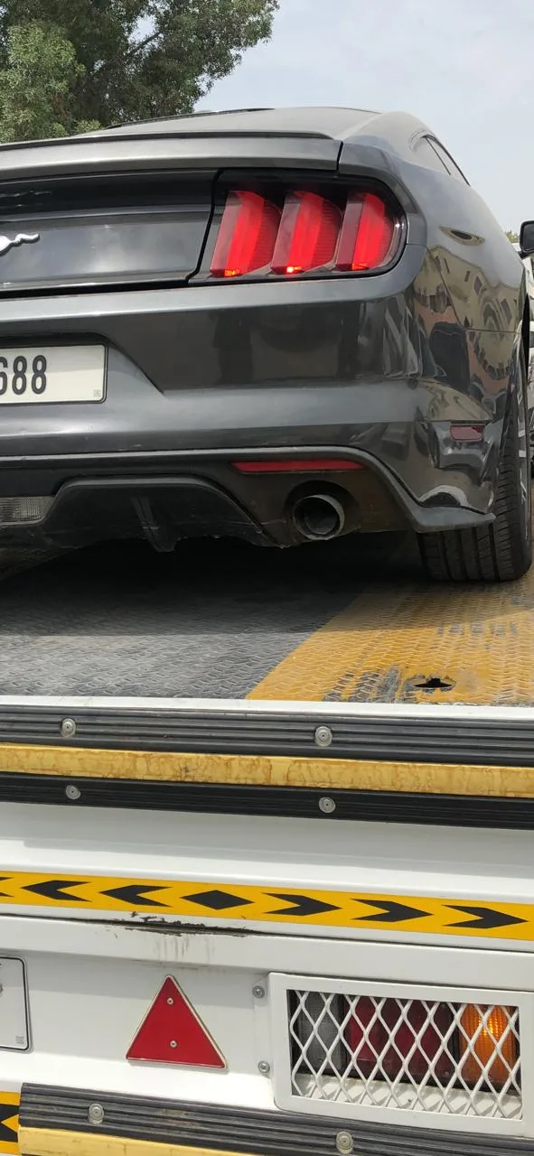 A car loaded onto a flatbed recovery truck