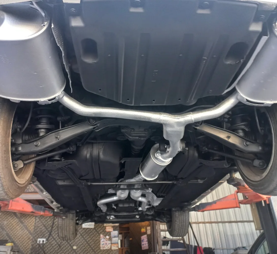 Underside of a car showing exhaust and rear suspension