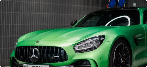 A bright green wrapped Mercedes-AMG GT inside the studio
