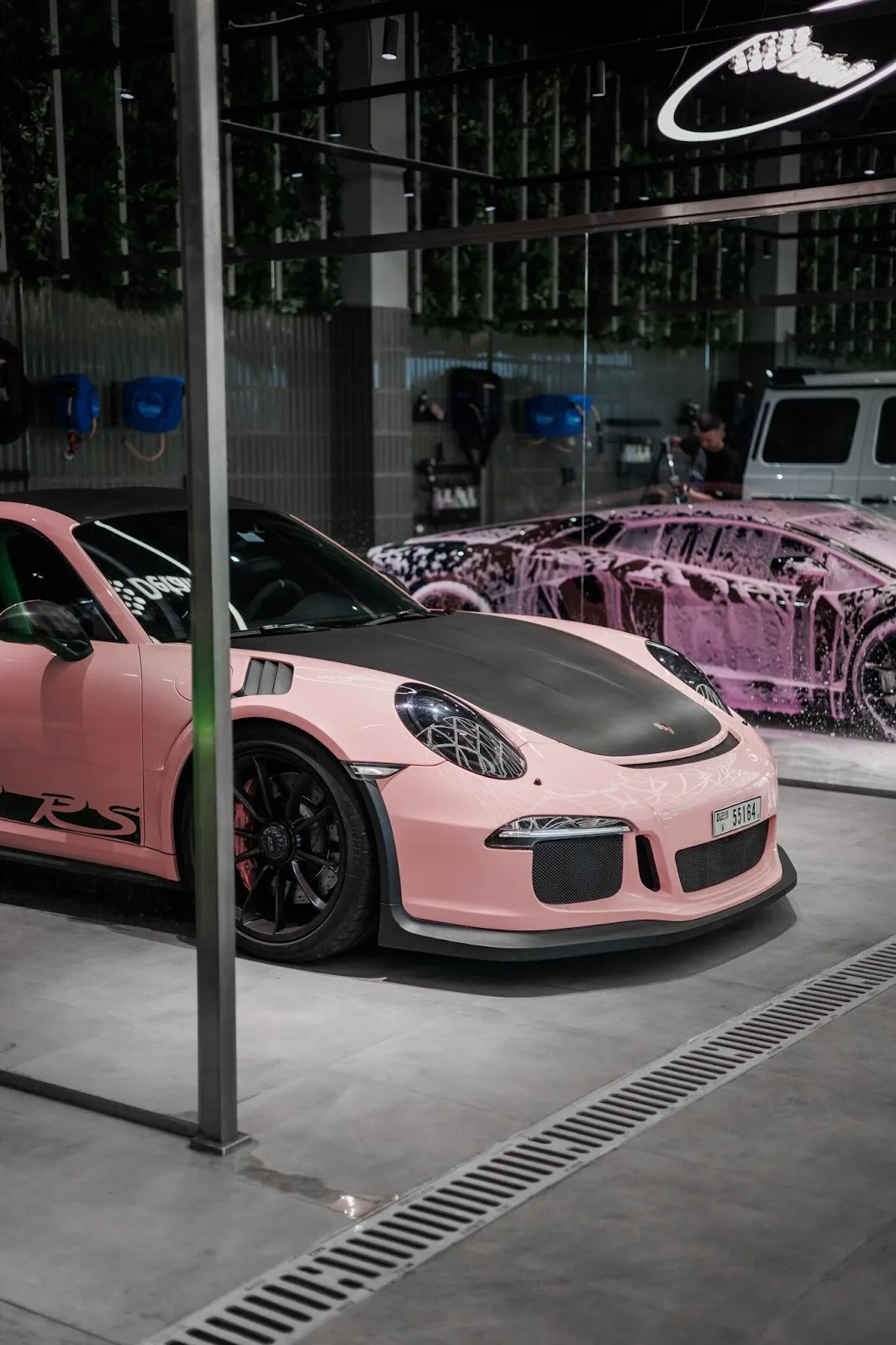 A pink Porsche 911 GT3 RS parked inside the studio