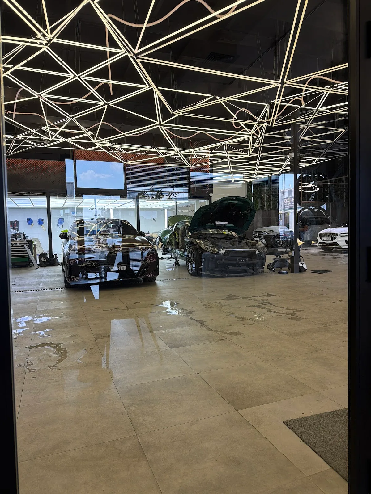 View into the studio bays under the geometric lit ceiling