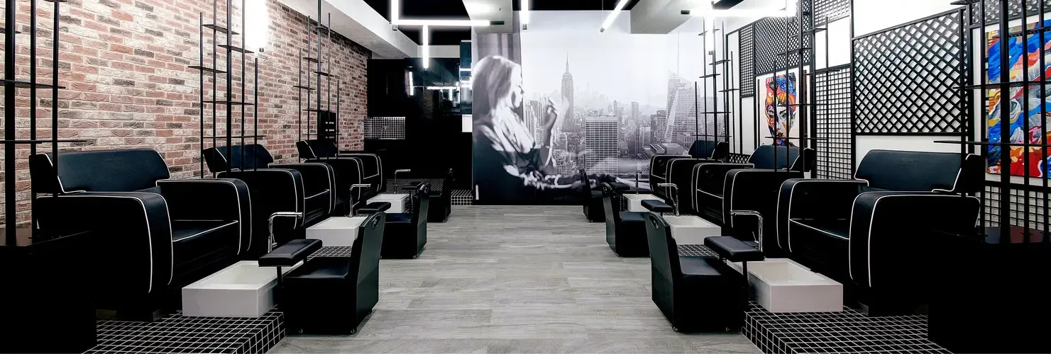 The loft's dark studio floor with a New York skyline mural and statement lighting