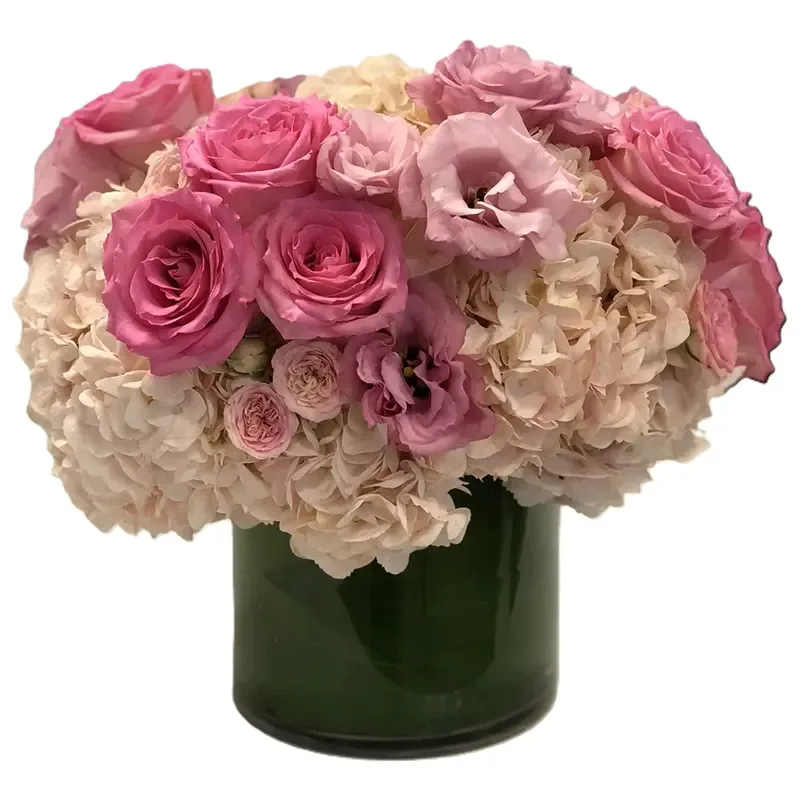 Blush roses and hydrangea in a low glass vase