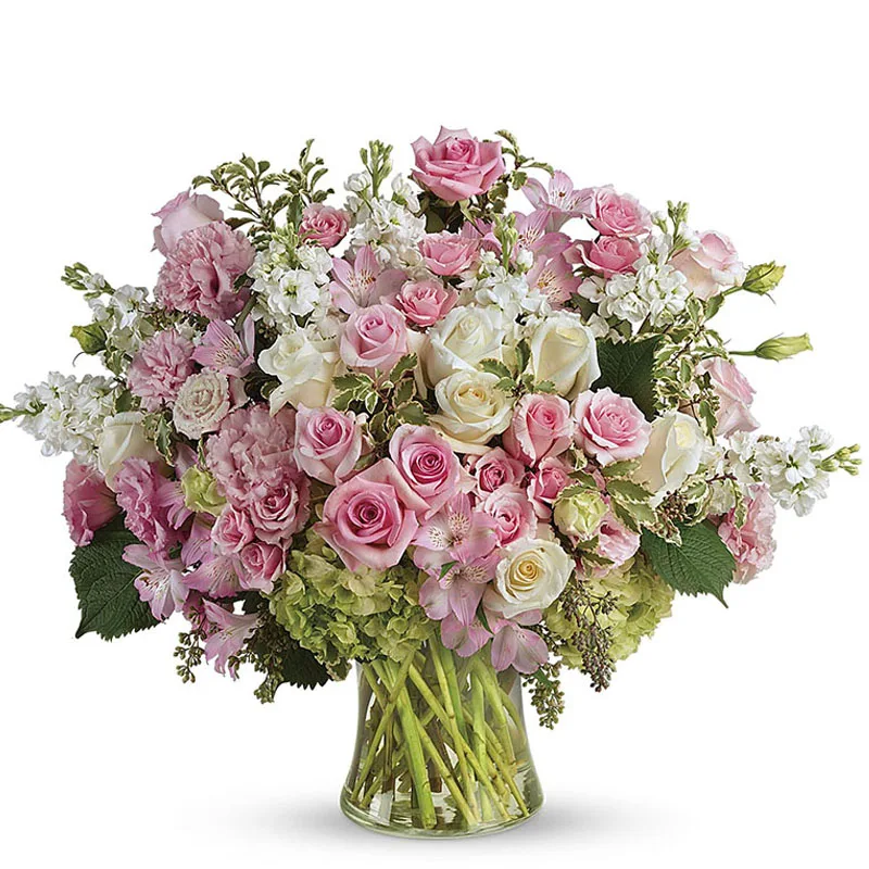 Tall blush and pink mixed bouquet arranged in a glass vase