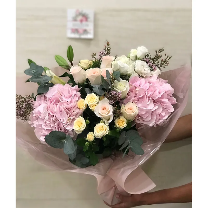 Hand-tied pink bouquet wrapped in soft paper