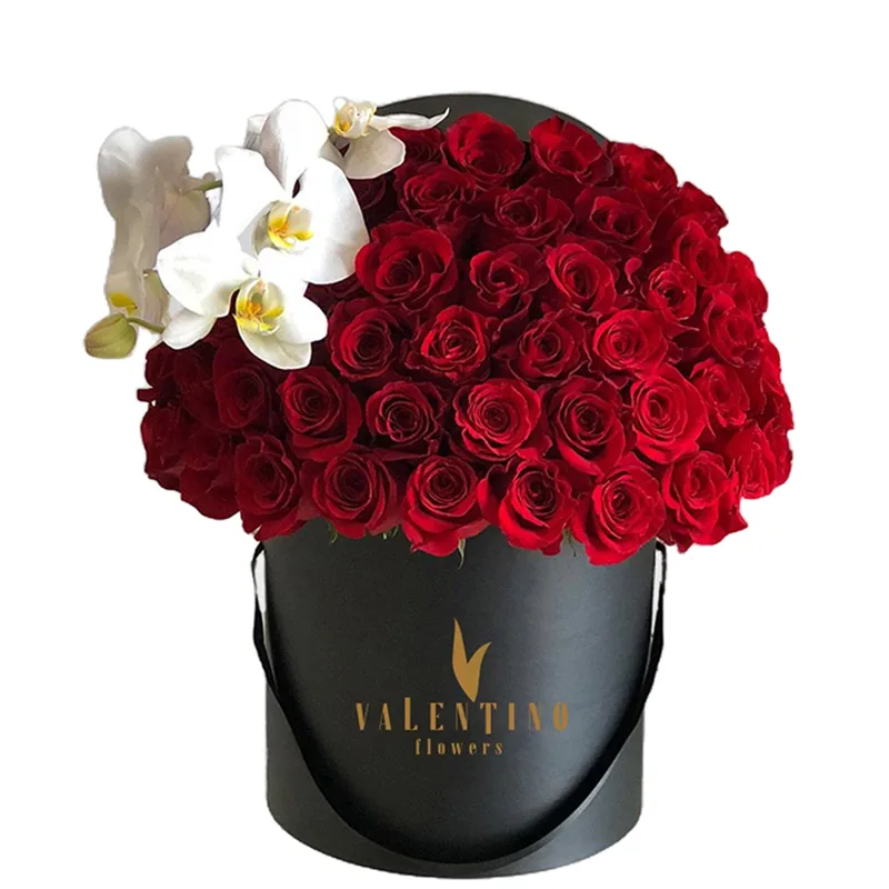 Dome of red roses crowned with white orchids in a black Valentino flower box