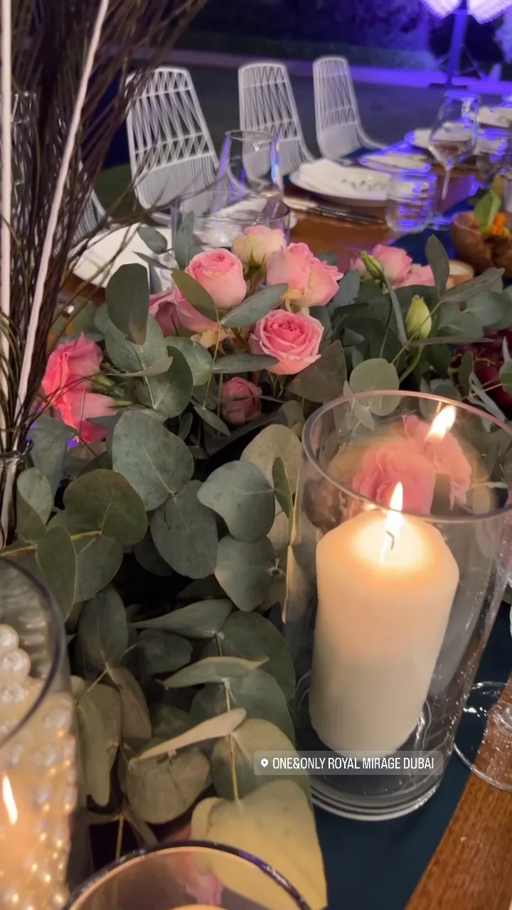 Eucalyptus and pink rose centrepiece with candlelight